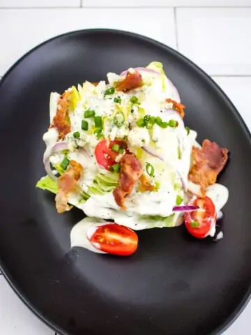 keto wedge salad topped with keto blue cheese dressing