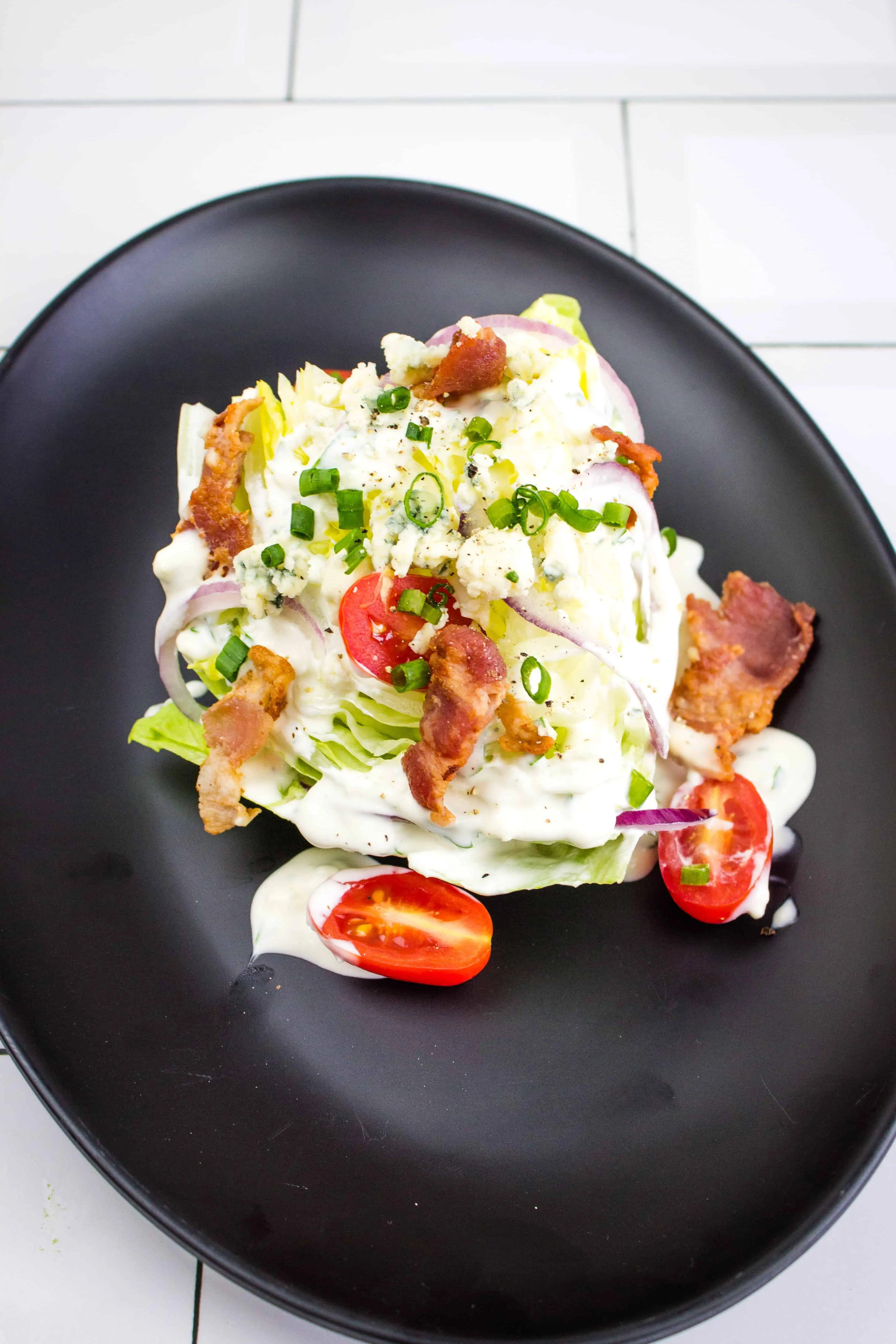 keto wedge salad topped with keto blue cheese dressing