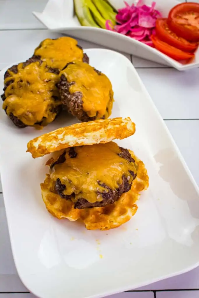 keto air fryer burgers on a plate with veggies in the background