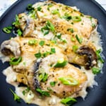 easy keto chicken marsala recipe on a black plate.