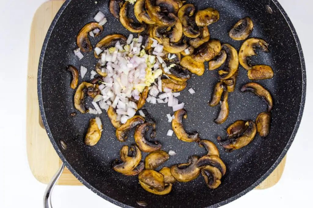 sauteeing mushrooms, shallot, and garlic in a skillet to make keto chicken marsala.
