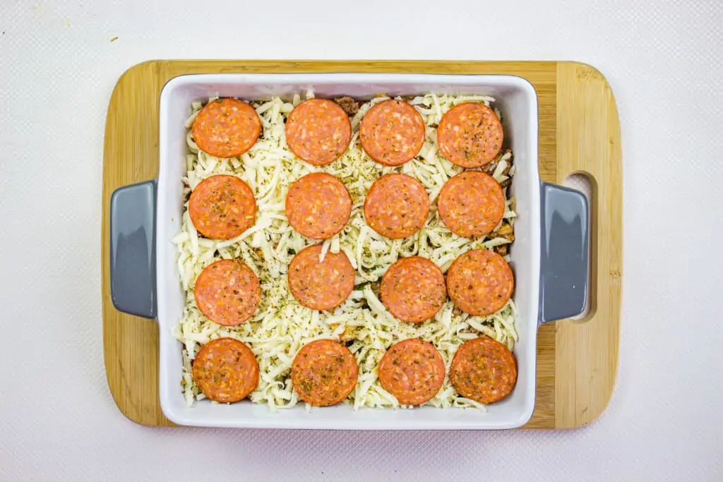 keto pizza casserole topped with cheese and pepperoni