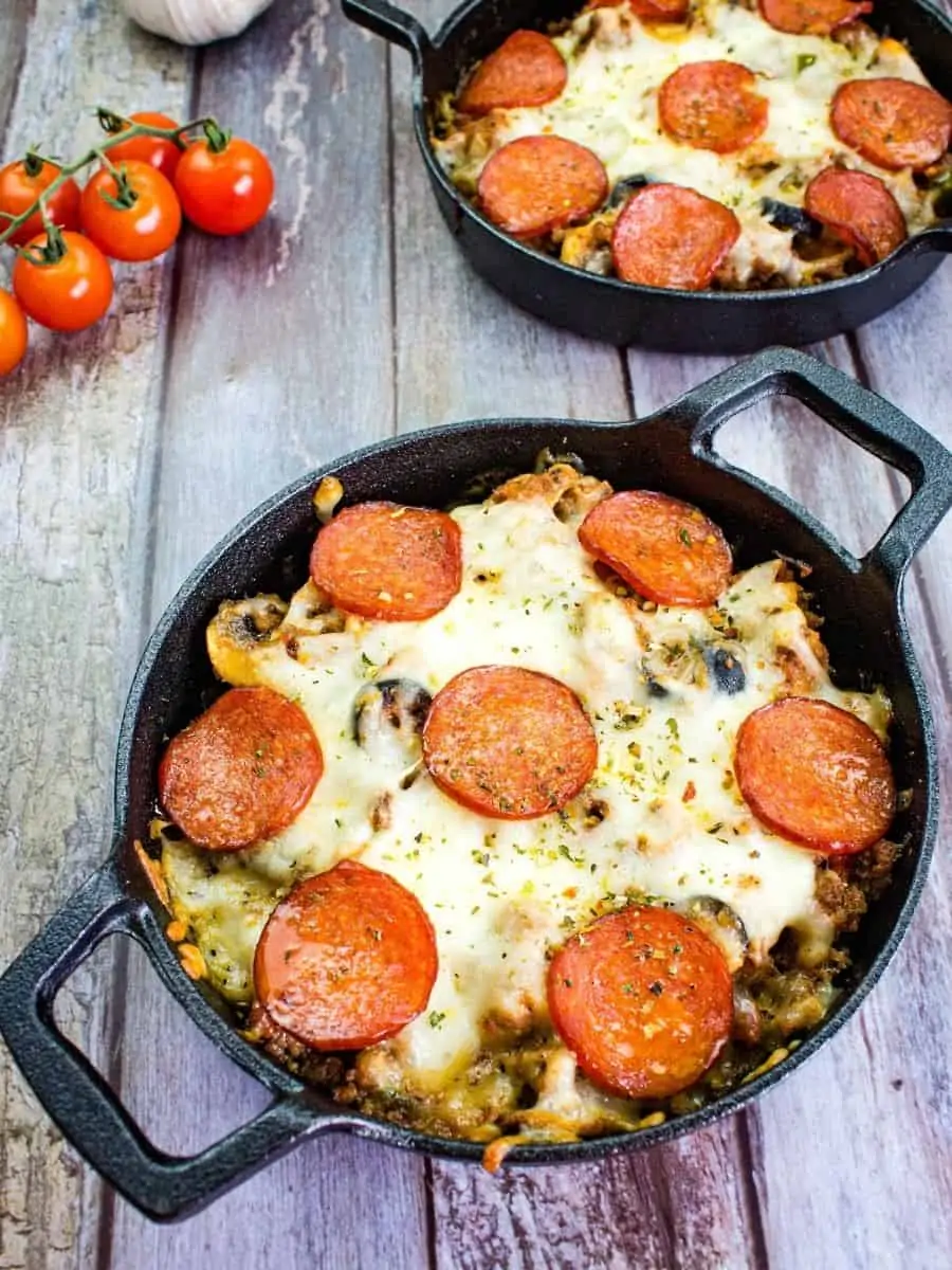 pizza casserole in a round black serving dish with a second in the background