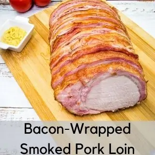 bacon wrapped smoked pork loin on a cutting board