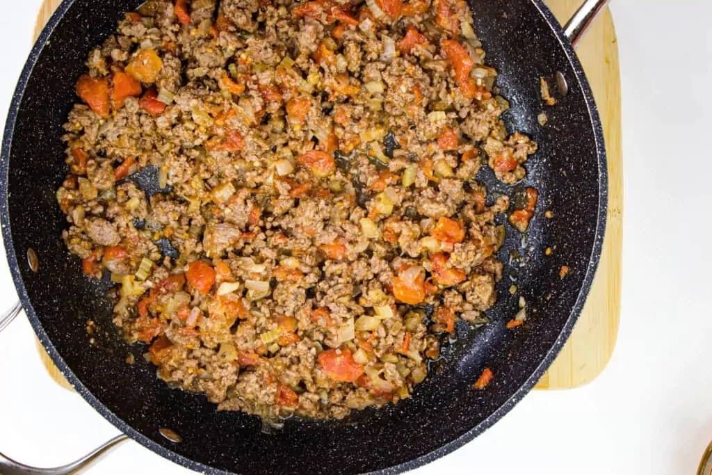 Add tomatoes to the filling and cook down