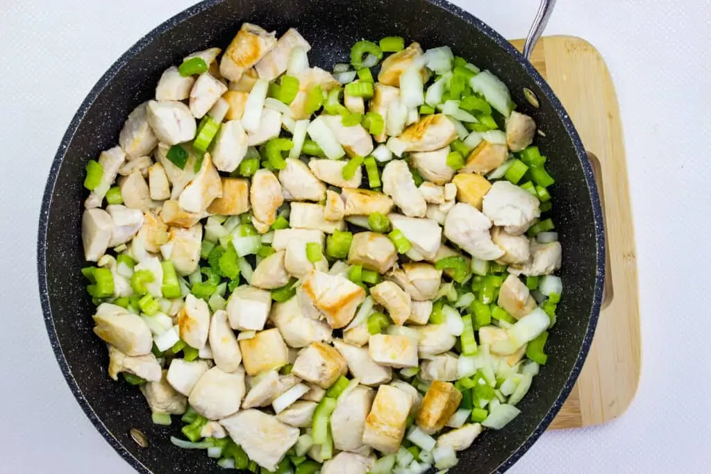 Browned chicken with veggies in pan