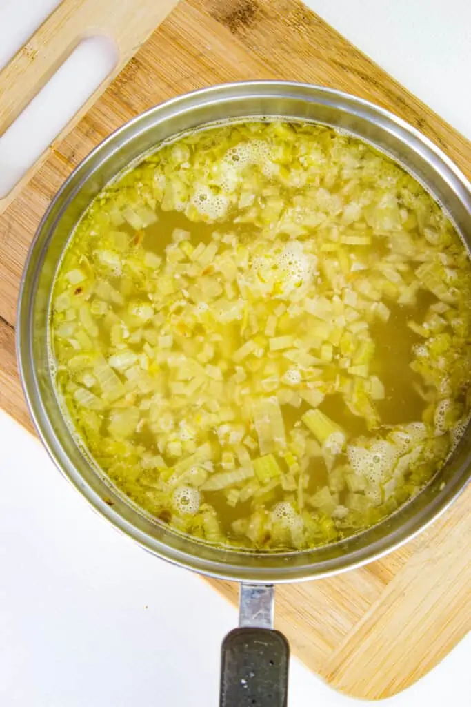 Simmering the onion, garlic, and celery.