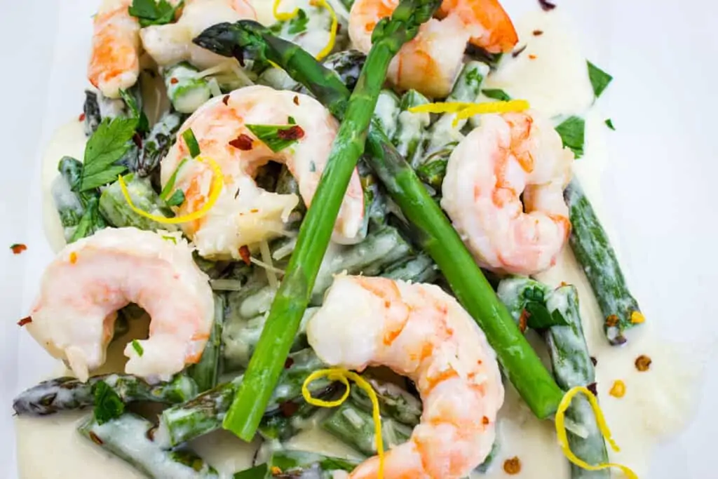 closeup of keto shrimp alfredo with asparagus