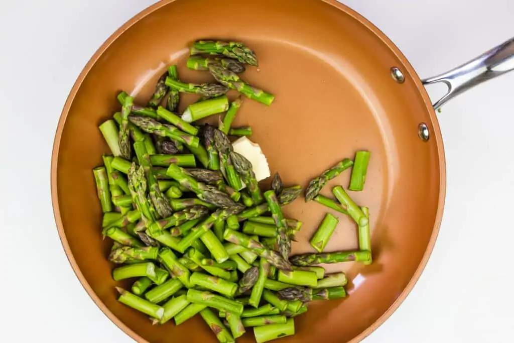 sauteeing the asparagus in butter