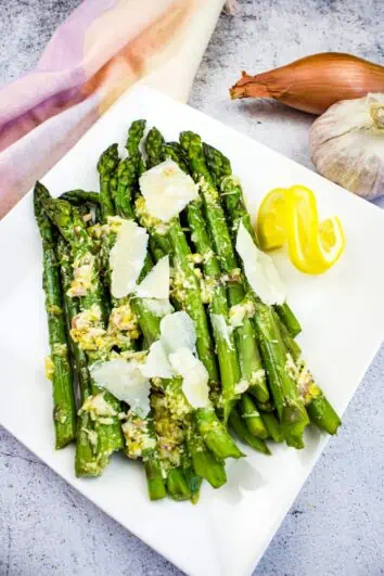 cold asparagus salad with lemon and parmesan on a platter