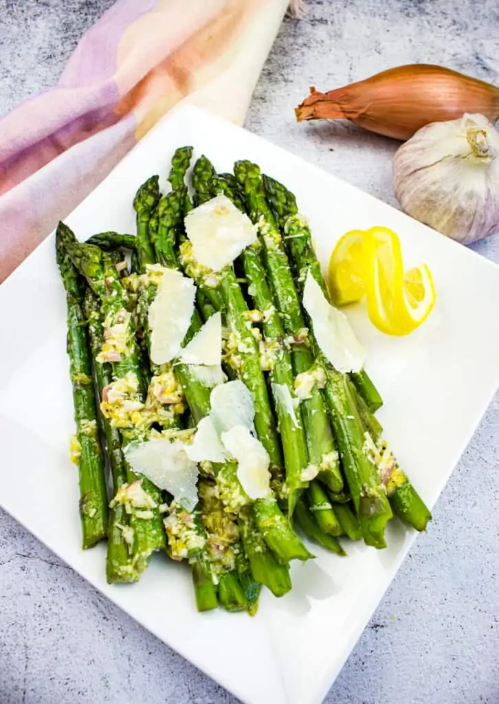 cold asparagus salad with lemon and parmesan on a platter