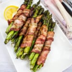 bacon-wrapped grilled asparagus bundles on a plate