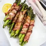 bacon-wrapped grilled asparagus bundles on a plate