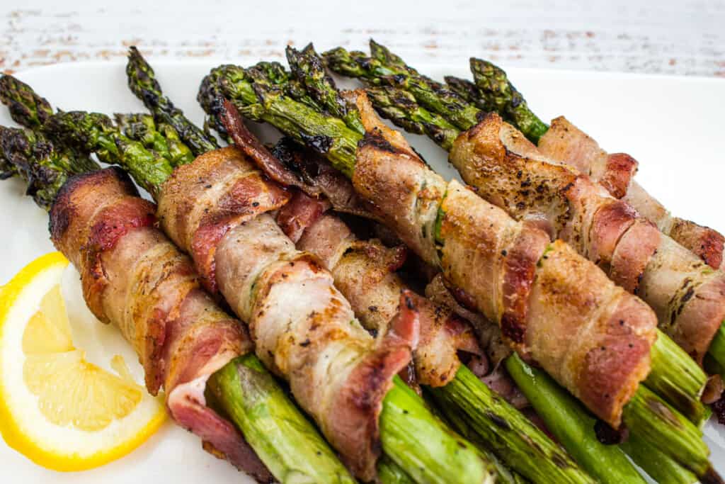 Bacon wrapped grilled asparagus on a plate.