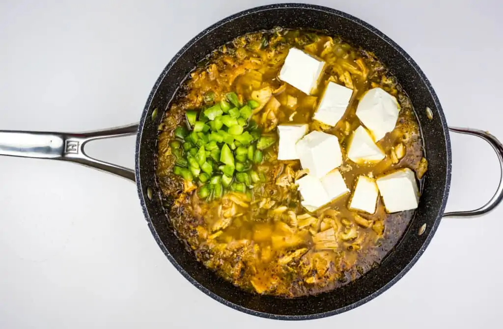 adding broth, cheese, peppers