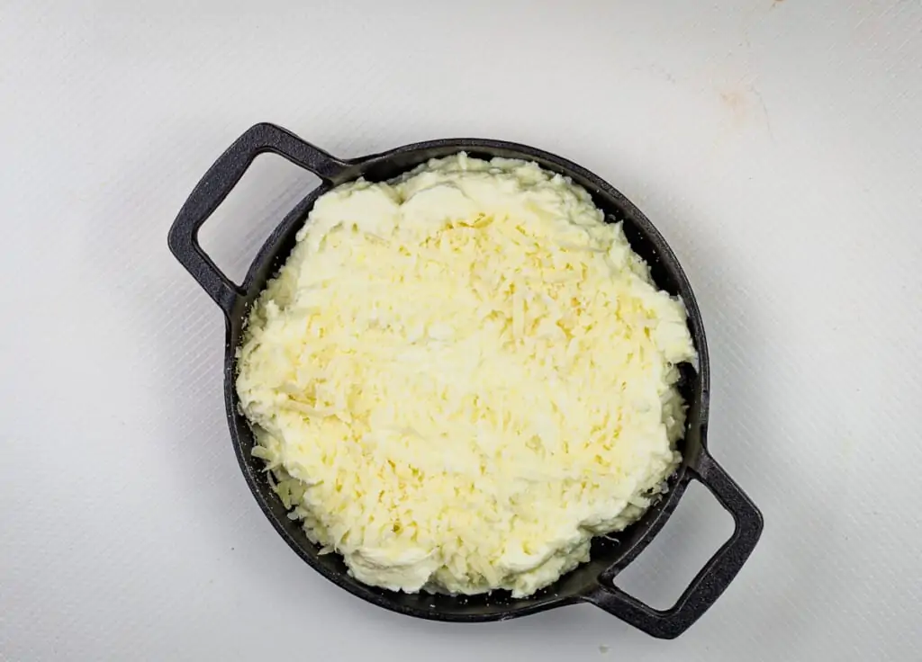 baked ricotta dip in a casserole dish topped with parmesan