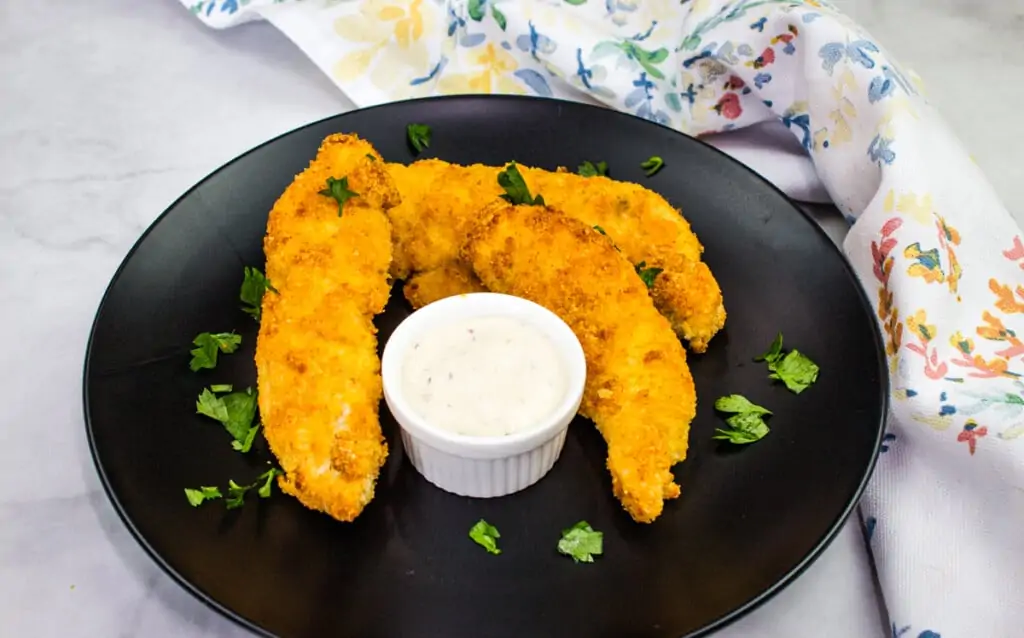 keto air fryer chicken tenders on a black plate