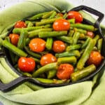 keto green beans and tomatoes in a black dish