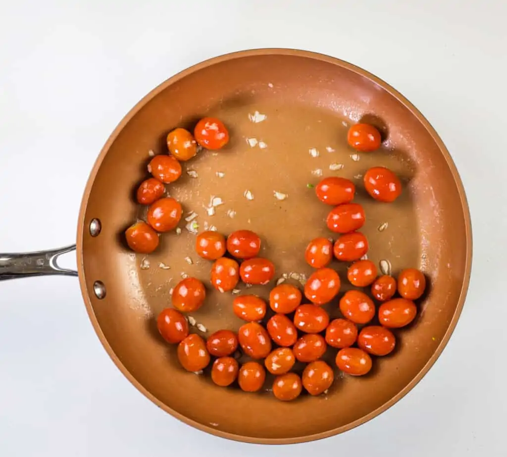 sauteeing the tomatoes and garlic