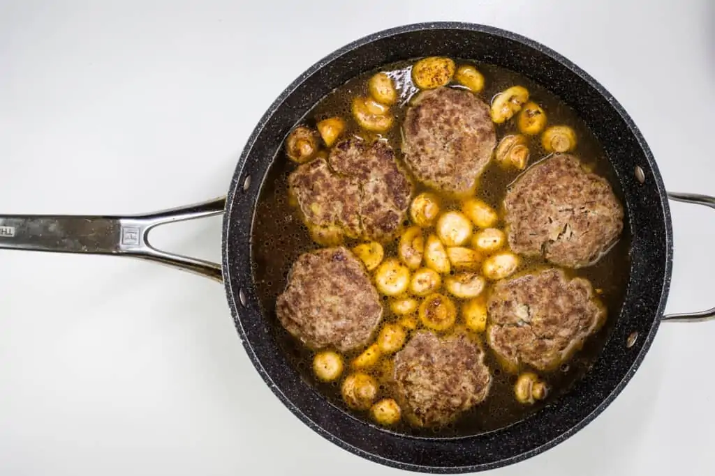 simmering the patties in broth