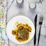 keto salisbury steak on a plate with mashed cauliflower