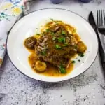 keto salisbury steak on a plate with mashed cauliflower