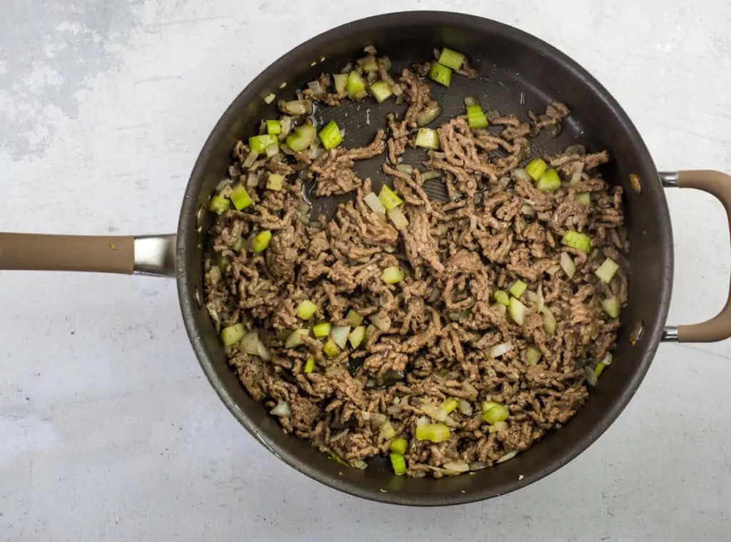 browning the beef and veggies in a pot