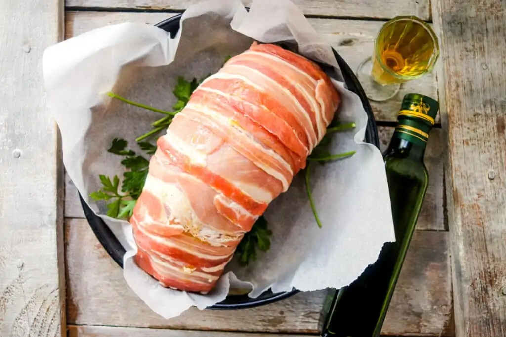 adding stuffed turkey roll to the baking dish