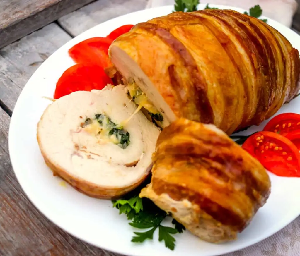 sliced stuffed turkey roll on a platter