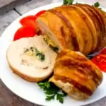 sliced stuffed turkey roll on a platter