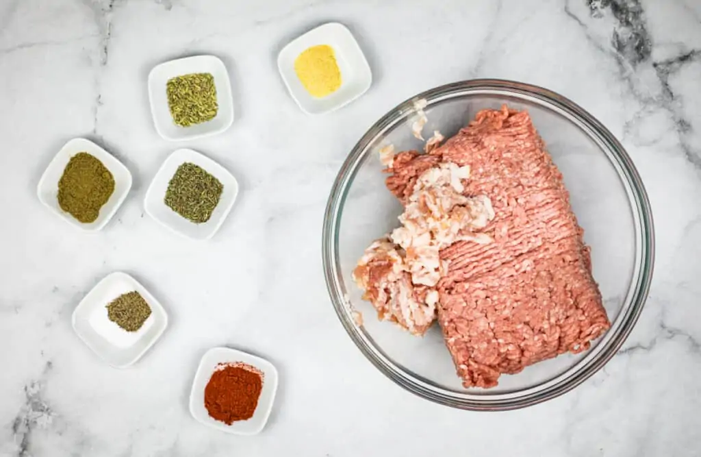 Finely chopped bacon in a bowl with ground pork to make keto Breakfast Sausage patties.