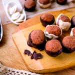 Chocolate peanut butter balls on a wood board.