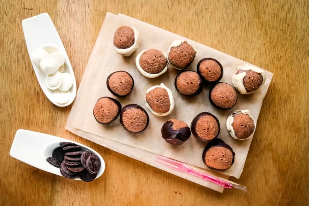 Keto peanut butter balls dipped into melted chocolate.