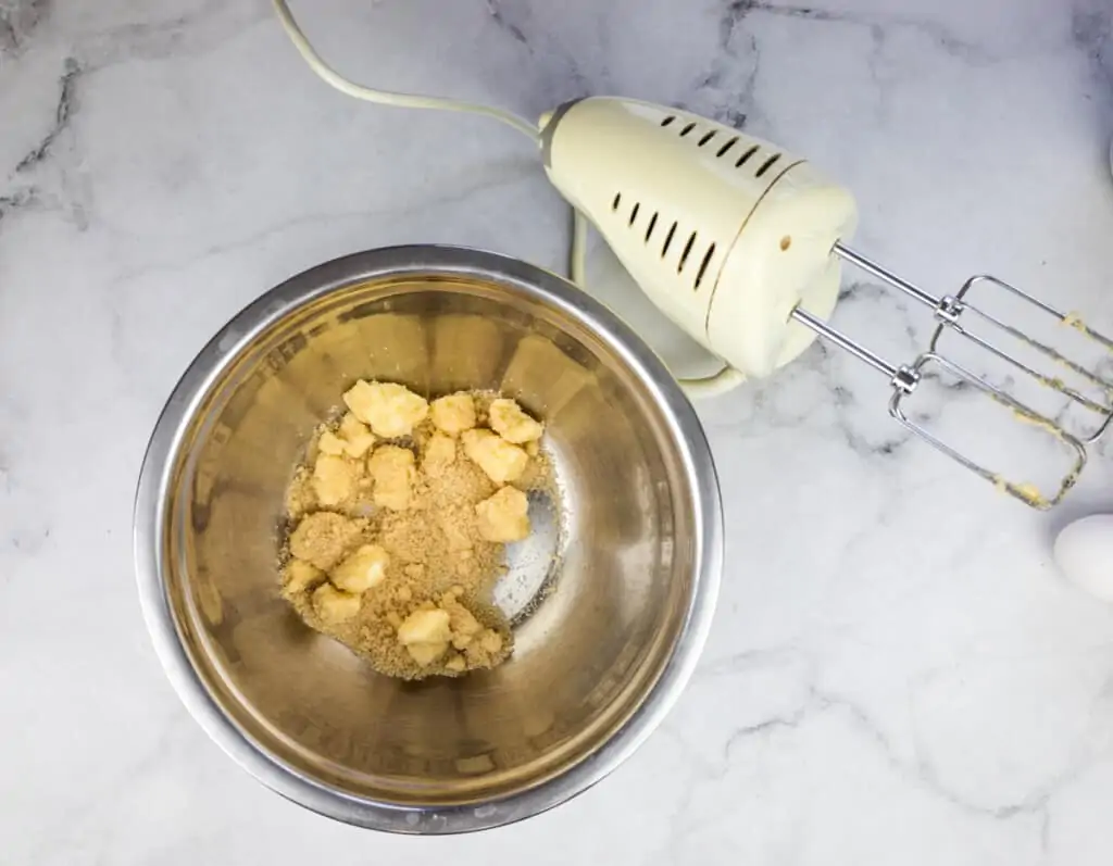 whipping butter and sugar in a bowl to make keto blueberry muffins