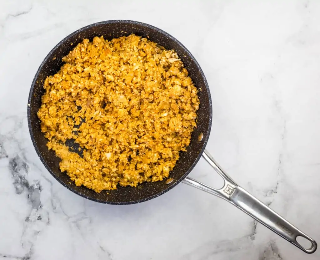 sauteeing the cauliflower and spices until tender