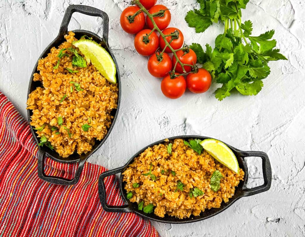 keto spanish cauliflower rice in two small black bowls