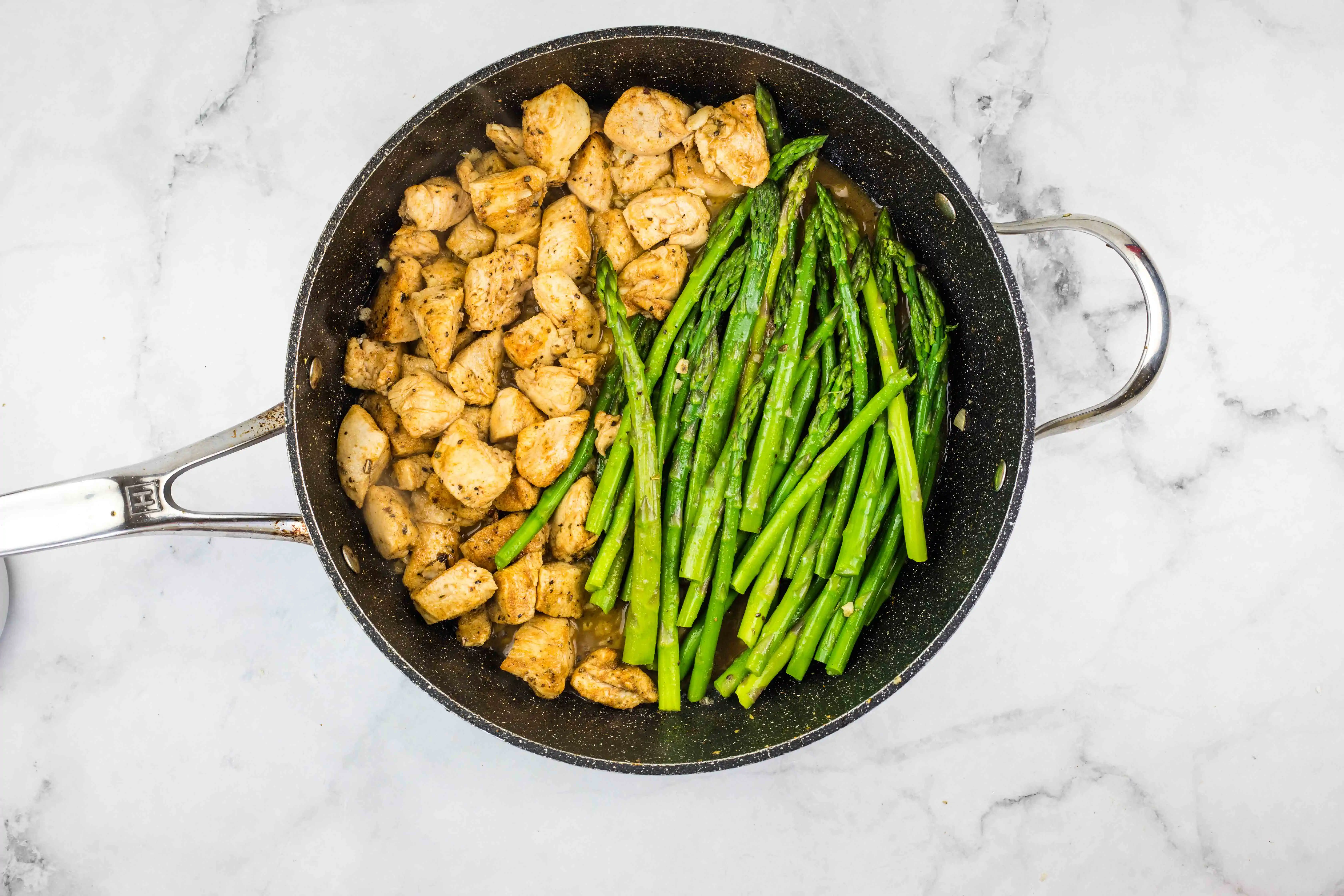 chicken and asparagus in the skillet