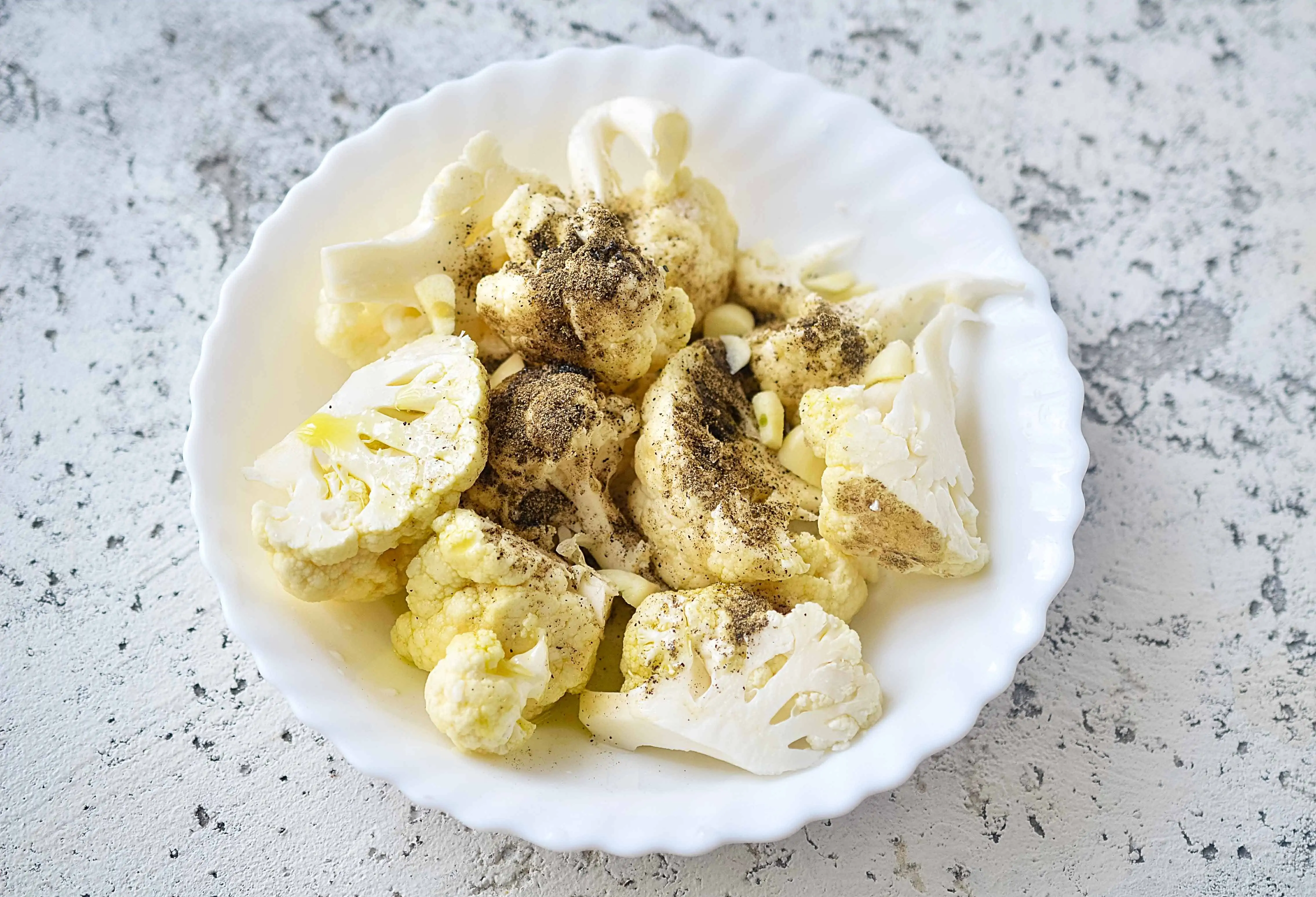 seasoned cauliflower ready for roasting