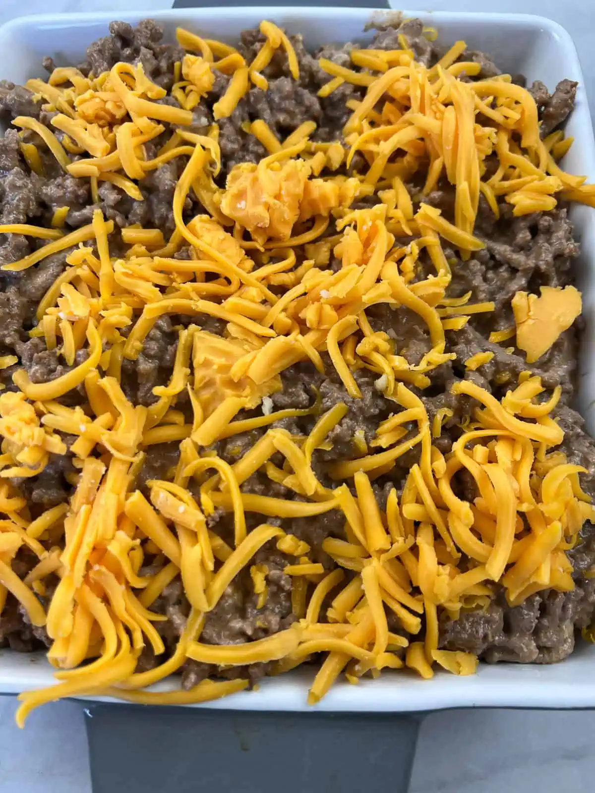 Layered into a baking dish and topped with cheese.