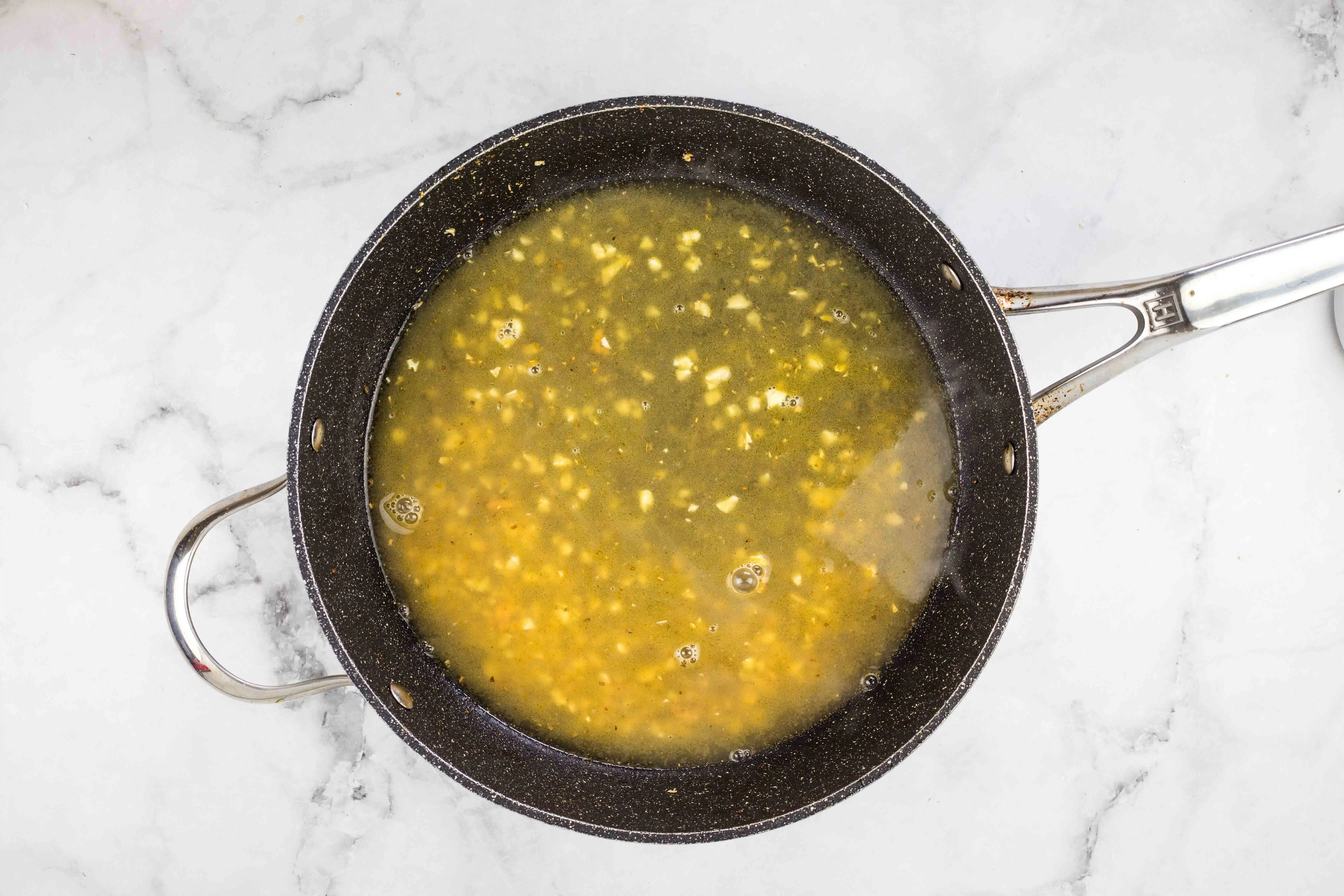 deglazing the pan with chicken broth