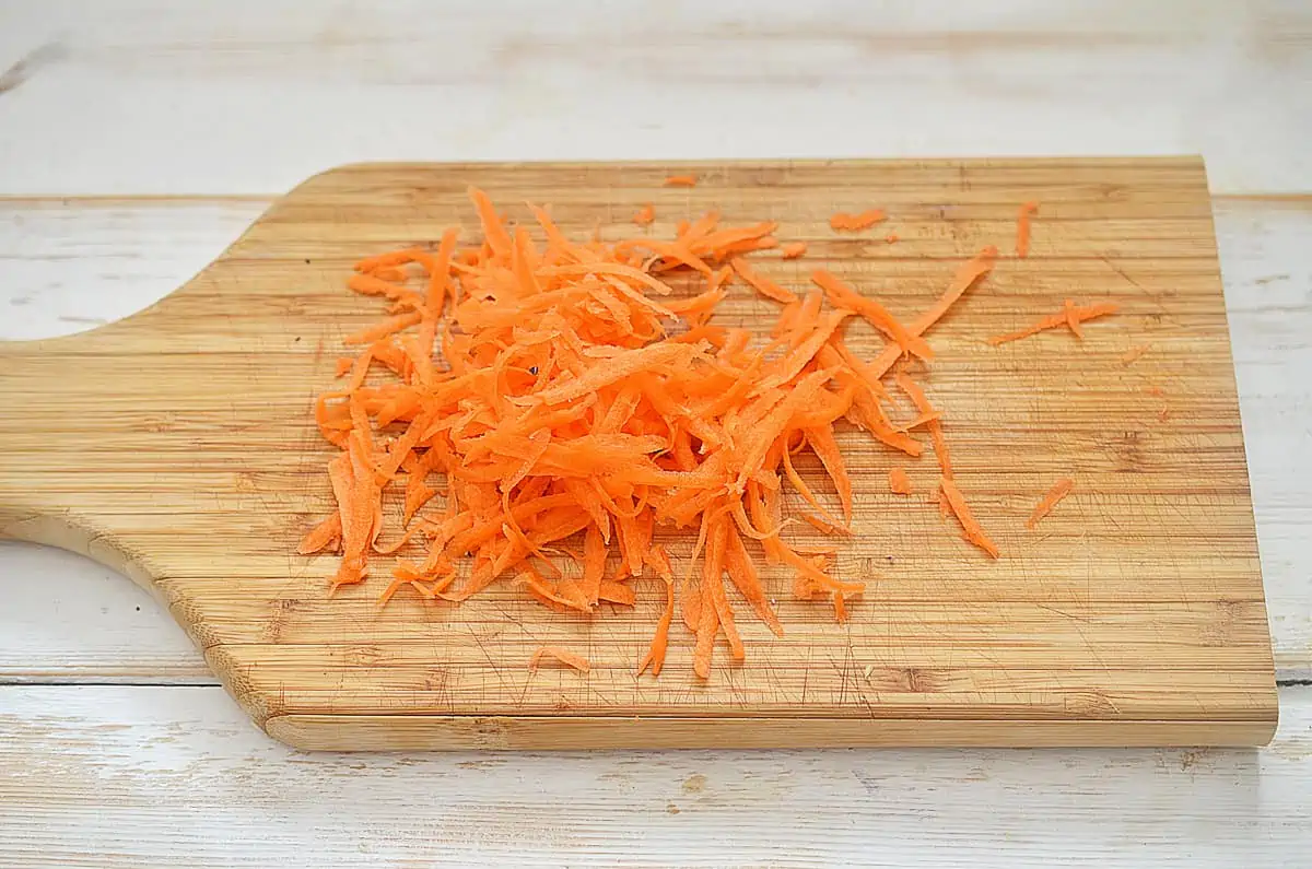 shredded carrot on a cutting board