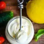 keto mayonnaise on a spoon with a lemon in the background
