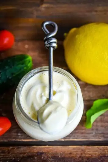 keto mayonnaise on a spoon with a lemon in the background