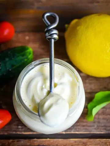 keto mayonnaise on a spoon with a lemon in the background