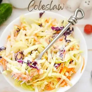 Keto coleslaw in a bowl with a fork.