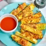 keto zucchini fries on a plate with sauce in a bowl