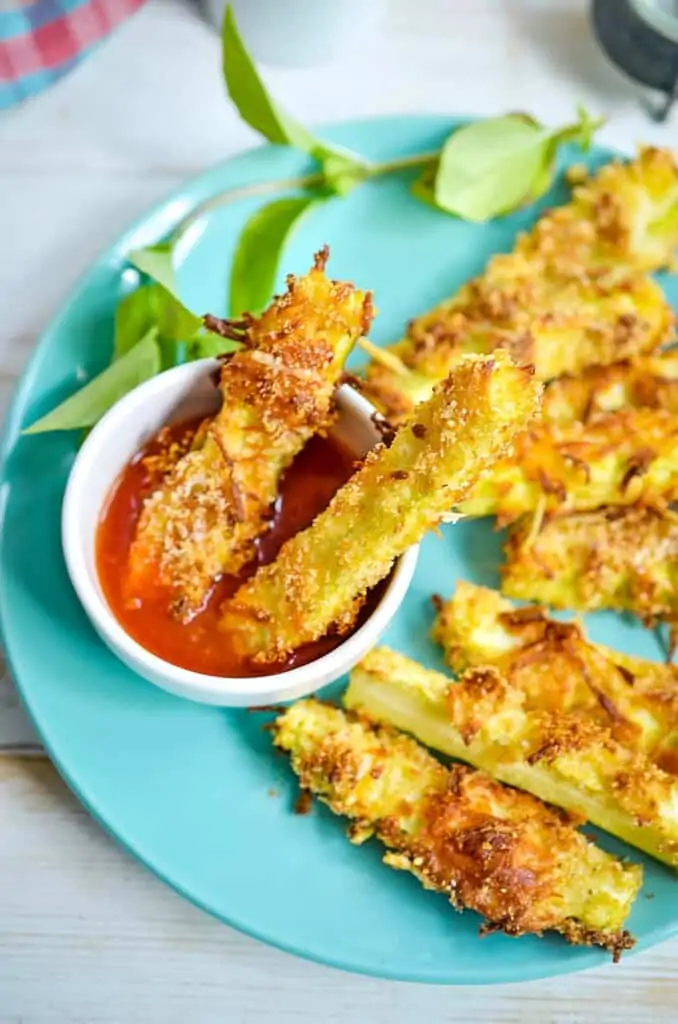 keto zucchini fries on a blue plate.