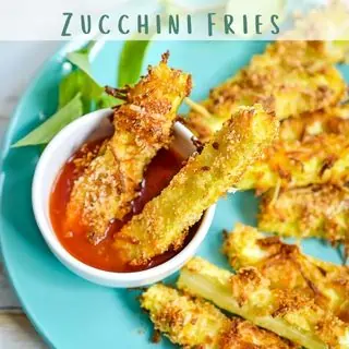 Zucchini fries on a plate with dipping sauce.