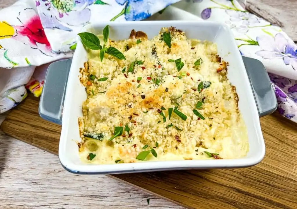 Chicken and zucchini bake in a square casserole dish.