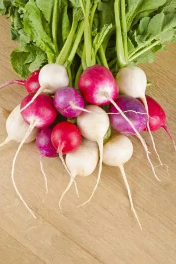 A pile of radishes on the counter.